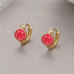 Gold huggie hoop earrings with red enamel smiley face charm and sparkling zircon stud