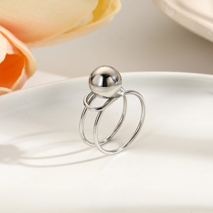 Detailed view of silver minimalist double-layered open ring with polished metal sphere