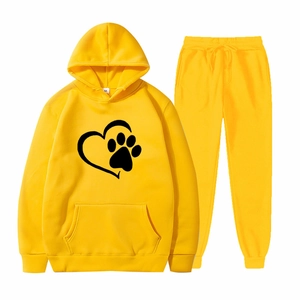 Two-piece bright yellow sports tracksuit with hoodie and sweatpants featuring heart paw print