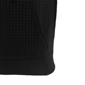 Detailed macro view of black waffle knit fabric with ribbed hem and stitching
