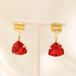 Detail of red teardrop glass earrings with gold stainless steel hooks on display
