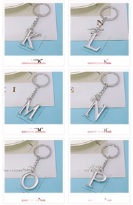 Detailed view of silver zinc alloy alphabet keychains with polished metallic finish