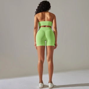 Detail of neon green seamless ribbed yoga set showing texture on back of top and shorts