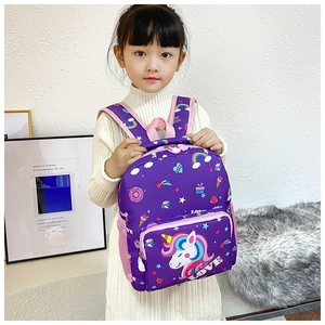 Toddler girl wearing a purple unicorn backpack with rainbow patterns and LOVE detail