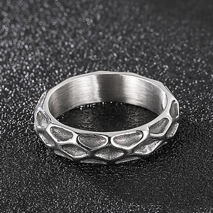 Macro shot of the irregular textured surface and honeycomb pattern on the silver ring