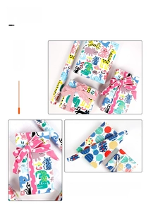 Detail of cartoon animal print wrapping paper with pink polka dot ribbon for gifts