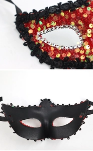 Close-up of red and gold sequin masquerade mask with black lace and silver rhinestone detail