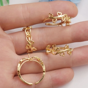 Macro shot of 14K gold-plated heart and vine ring bases for DIY pearl mounting
