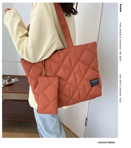Detail of brick red quilted tote bag with matching detachable small coin purse pouch
