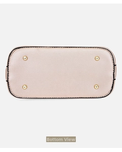 Close-up of the champagne gold handbag base featuring four protective metal feet