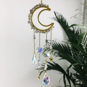 Detail of golden moon suncatcher with amethyst beads and crystal prisms for window