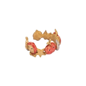 Detailed macro view of an adjustable ring featuring gold stars and red apple characters