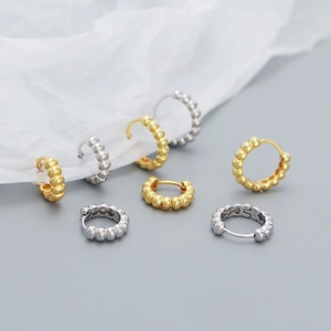 Close-up of S925 sterling silver hoop earrings with bead design in gold and silver finish