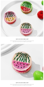 Detail shot of watermelon acetate hair claw with glossy jelly finish on white display