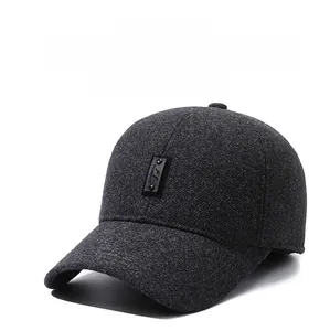 Close-up of gray knitted winter baseball cap showing texture and leather fashion logo