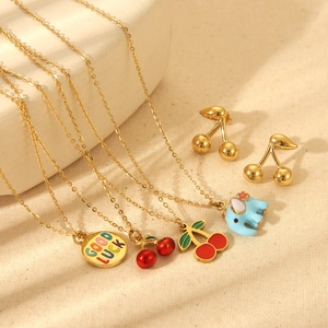 Gold-plated stainless steel jewelry set featuring cherry and elephant pendants