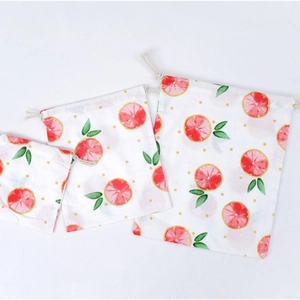 Three-piece set of drawstring storage bags with grapefruit print in small, medium, large