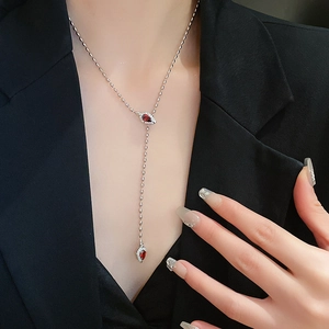 Silver Y-shaped necklace featuring two pear-cut red zircons and pavé diamonds