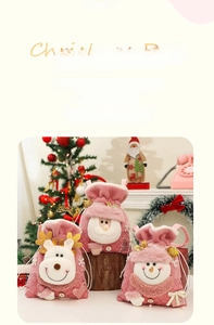 Close-up of pink Christmas drawstring gift bags with plush Santa, elk, and snowman designs