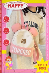 Detail of a pink and cream kids' backpack featuring 3D ears and smiley face detail