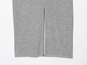 Detail of side slit stitching on gray knitted midi skirt showing fabric texture
