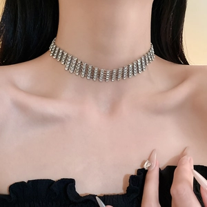 Detail of silver five-row rhinestone choker necklace with luxury crystal layering