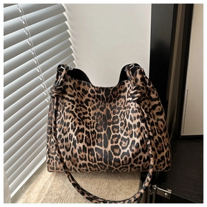 Detail shot of the knot design on the leopard print shoulder bag with a stylish hobo shape