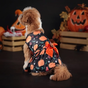 Detailed view of the Halloween pumpkin dog dress with a large sequined orange bow