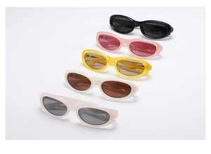 Macro view of assorted oval vintage sunglasses in black pink yellow white and beige colors