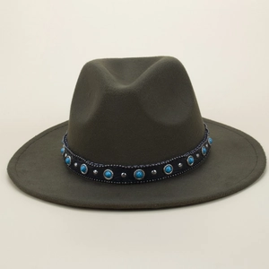 Close-up of olive green fedora with black leather band and turquoise stone studs