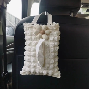 Cream floral car tissue holder hanging on seat back made of bubble textured fabric