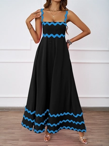 Detail shot of the black summer dress featuring elegant blue wavy trim and thin straps