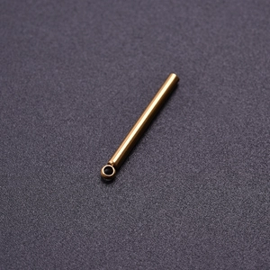 Close-up of golden stainless steel bar pendant component with polished metallic finish