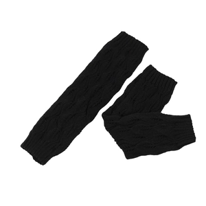 Detailed knit texture of black leg warmers with cable knit and diamond patterns
