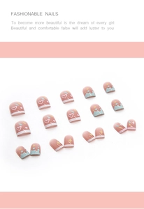 Detail view of pink press-on nails set with heart and star patterns in candy colors