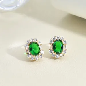 Vintage emerald-style green zircon earrings surrounded by white crystals in gold plating