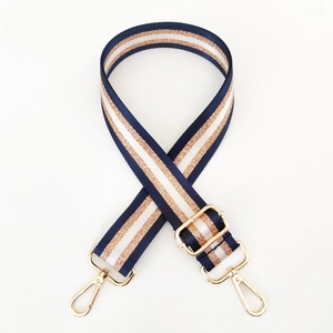 Adjustable wide nylon shoulder strap with navy, white and gold glitter stripes and gold buckles