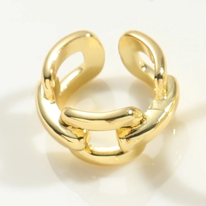 Macro detail of gold anchor chain ring with polished mirror finish and adjustable opening