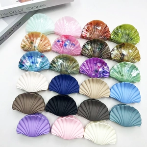 Shell-shaped marble texture hair claws set in assorted colors on a clean white surface