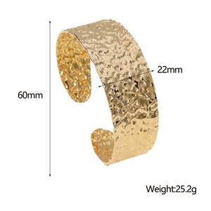 Detail showing 60mm diameter and 22mm width measurements of the hammered gold bangle