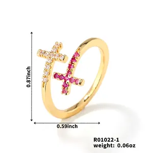Detail view of gold cross ring featuring micro-pave white and pink zircon crystals