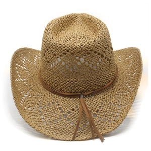 Detail of straw cowboy hat featuring hollow weave, brown leather cord, and silver tassels
