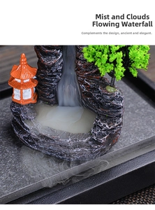 Detail of backflow incense burner showing waterfall smoke effect over resin rock landscape