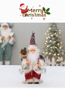Detail of Santa Claus plush doll featuring red plaid fabric and festive pine cone pocket
