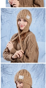 Detail of brown chunky knit trapper hat with colorful flecks and white square patch