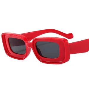 Trendy red thick square sunglasses with dark lenses in a stylish Y2K retro fashion style