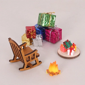 Miniature Christmas set with wooden rocking chair, tiny gift boxes, and fire pit model