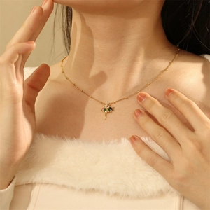 Detail of ballerina pendant necklace with colorful zircons on a delicate gold chain