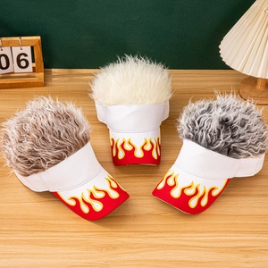 Detail showing white flame visors with brown, cream, and grey wig hair on wood desk