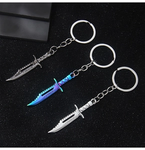 Detailed view of silver and blue Cross Fire alloy game knife model keychains